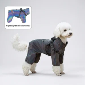 White Bichon Frise standing on plain light gray studio backdrop, wearing iridescent dark full-body four-leg dog rain suit with reflective harness straps; small inset graphic shows night light reflection effect of the fabric